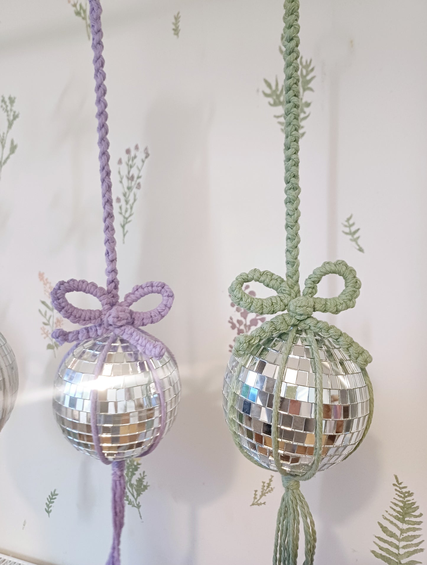 Two macrame disco mirror balls with bows