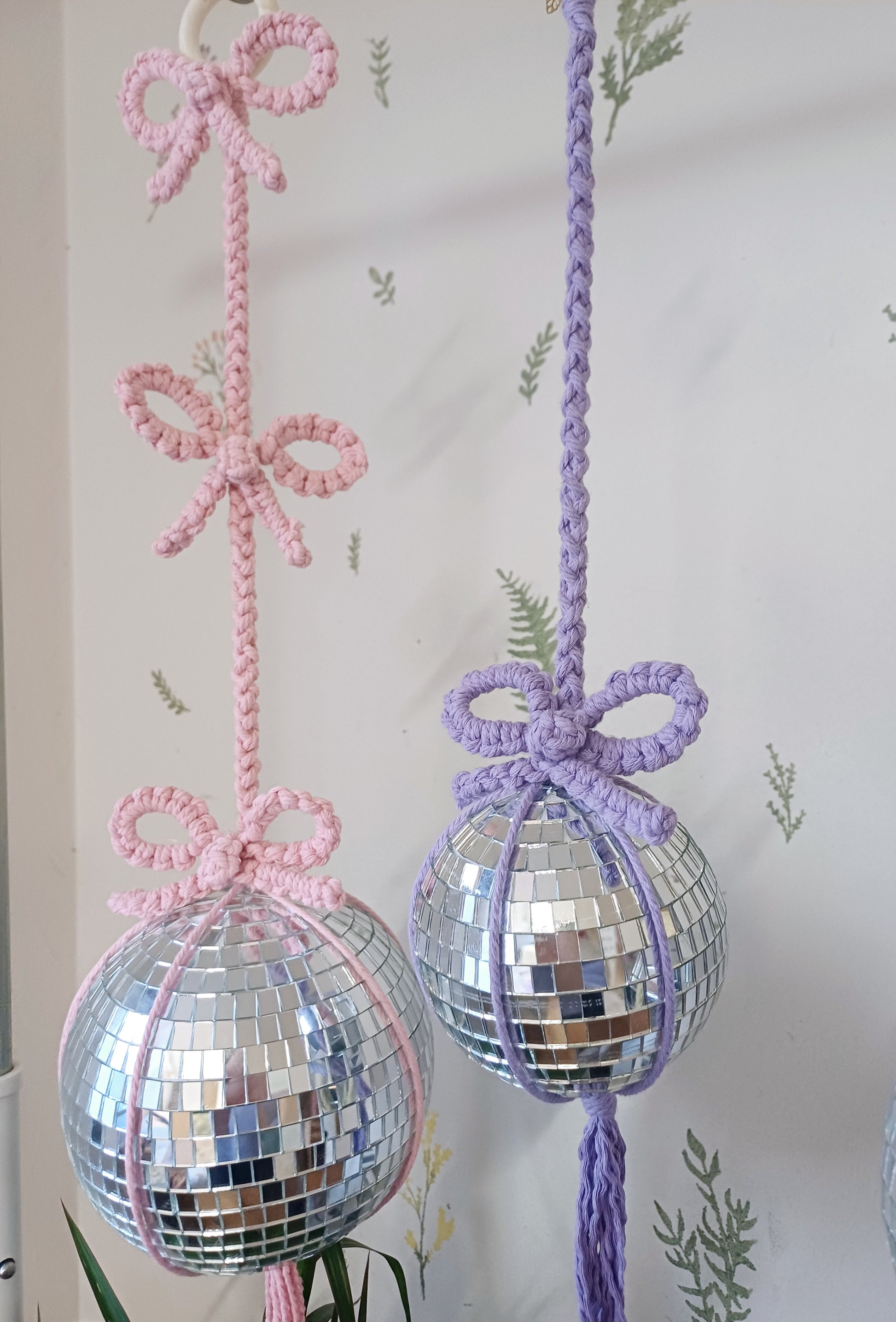 Pink macrame disco mirror ball and a purple disco ball with bows